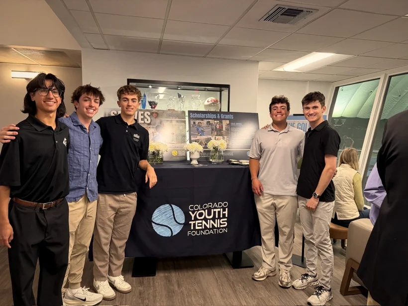 Sam Iannone with four friends beside the Colorado Youth Tennis Foundation table