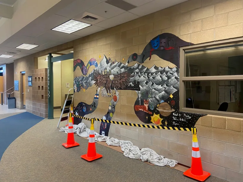 A mural in progress in a Wayne Carle Middle School hallway