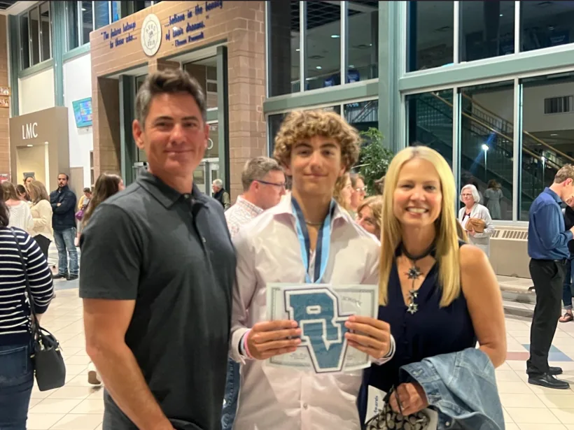 Sam Iannone holding a Ralston Valley award with his family