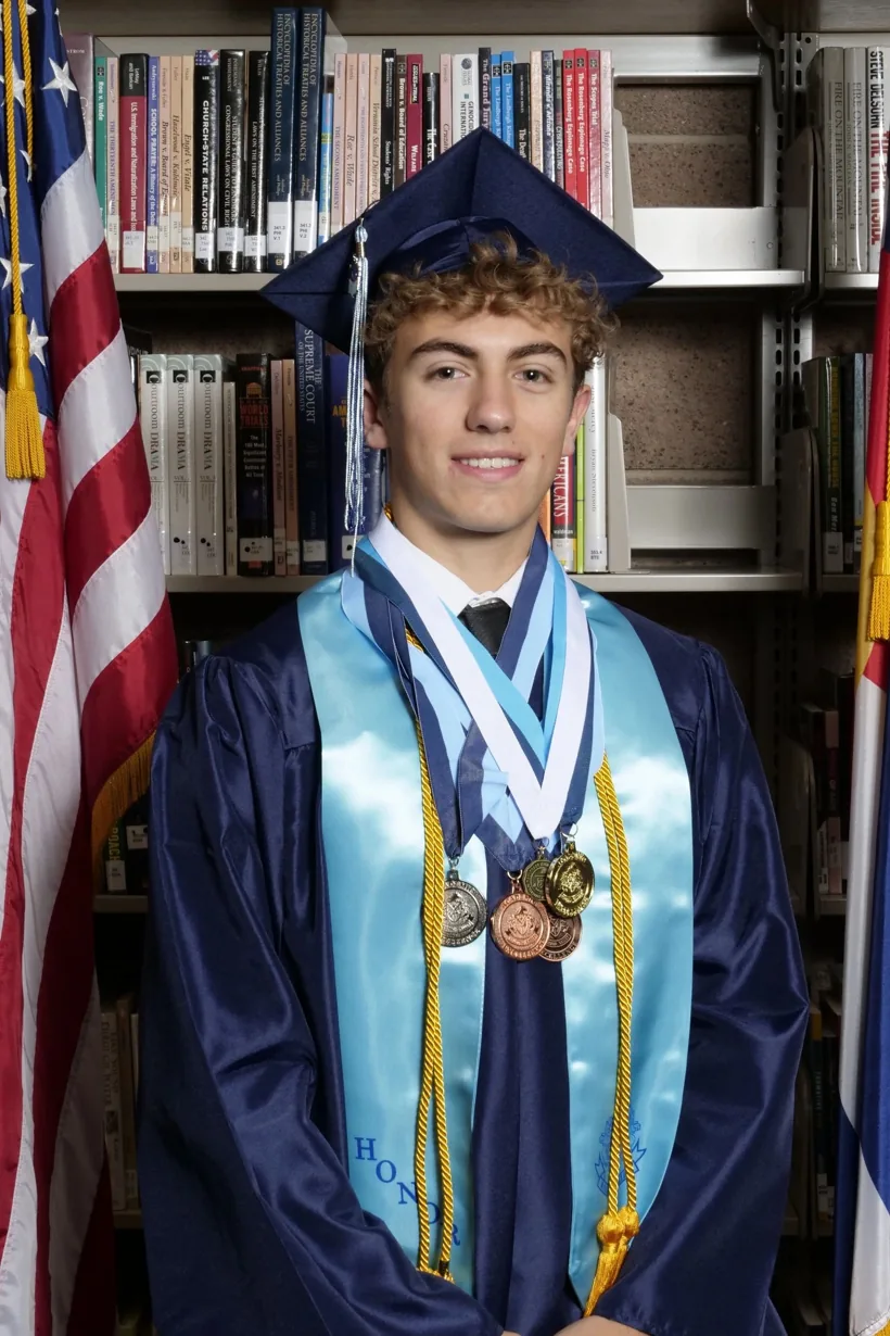 Sam Iannone in graduation cap and gown with honor cords and medals